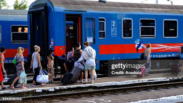 People are seen at a train station as Ukrainians, staying in the refugee centers, continue their journey to different cities in Europe after arriving...