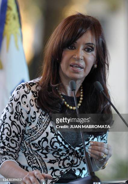Argentine President Cristina Fernandez de Kirchner gestures during a news conference next to Uruguayan President Jose Mujica after a meeting at...