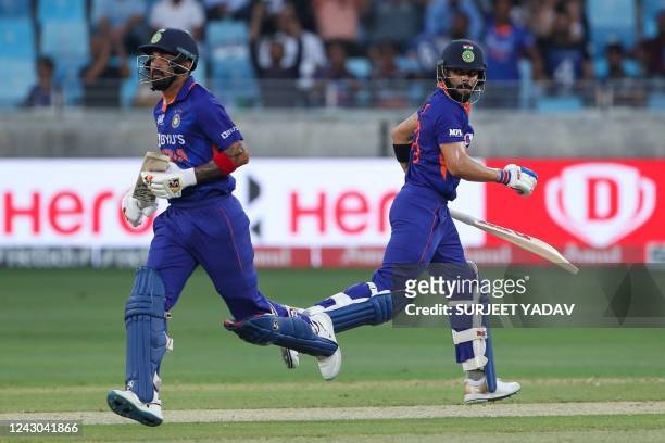 India's KL Rahul and Virat Kohli take a run during the Asia Cup Twenty20 international cricket Super Four match between Afghanistan and India at the...