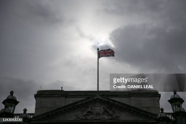 Britain's national flag flaps in the wind over Buckingham Palace, central London, on September 8, 2022. - Fears grew on September 8, 2022 for Queen...