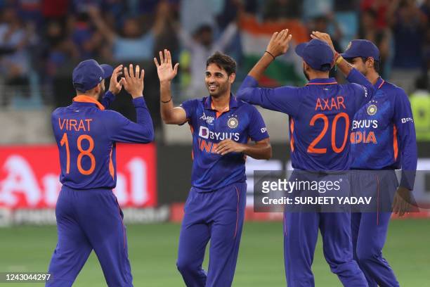 India's Bhuvneshwar Kumar celebrates with teammates after bowling out Afghanistan's Rahmanullah Gurbaz during the Asia Cup Twenty20 international...