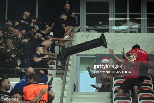 Supporters throws a heavy object at others as a fight between FC Cologne and Nice's supporters erupted ahead of the UEFA Europa Conference League...