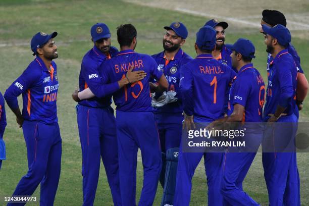 India's Bhuvneshwar Kumar celebrates with teammates after dismissing Afghanistan's Azmatullah Omarzai during the Asia Cup Twenty20 international...