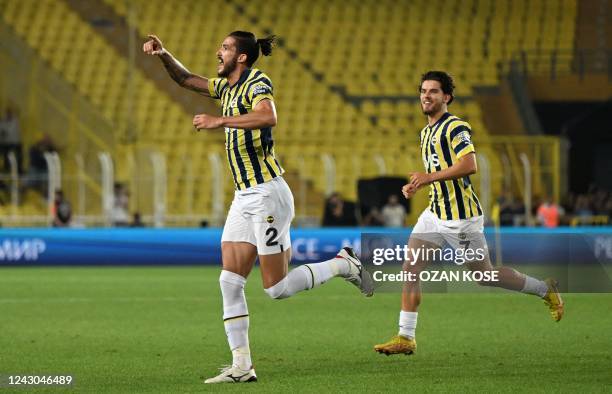 Fenerbahce's Bazilian defender Gustavo Henrique celebrates with teammate Fenerbahce's Turkish midfielder Ferdi Kadioglu after scoring the 1-0 goal...