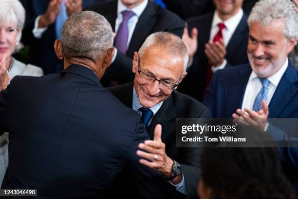 John Podesta, center, greets former President Barack Obama during the official White House portrait unveiling ceremony for Obama and former First...