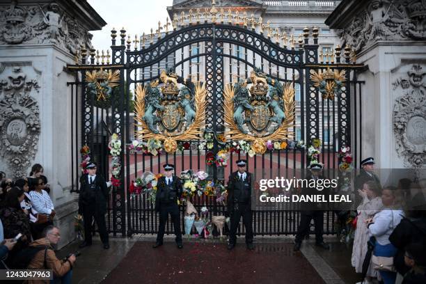 Wellwishers arrive to place flowers at the gates of Buckingham Palace, after the announcement of the death of Queen Elizabeth II, in central London...