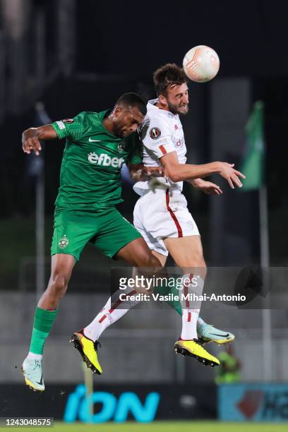 Bryan Cristante of AS Roma jumps for the ball with Olivier Verdon of Ludogorets during the UEFA Europa League group C match between PFC Ludogorets...
