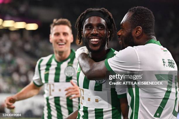 Ferencvaros' Norwegian forward Tokmac Nguen celebrates his goal with his teammates Ferencvaros' Ivorian forward Franck Boli and Ferencvaros'...