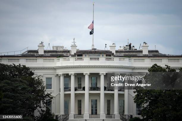 The American flag on top of the White House is lowered to half staff in memory of Queen Elizabeth II on September 08, 2022 in Washington, DC. U.S....