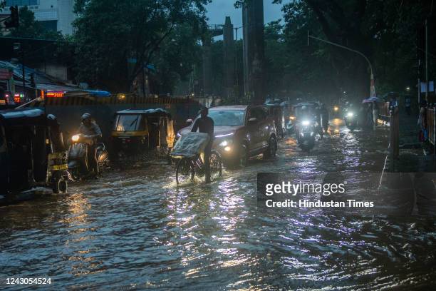 Vehicles wade through waterlogged street due to heavy rainfall near Kanjurmarg on September 8, 2022 in Mumbai, India.