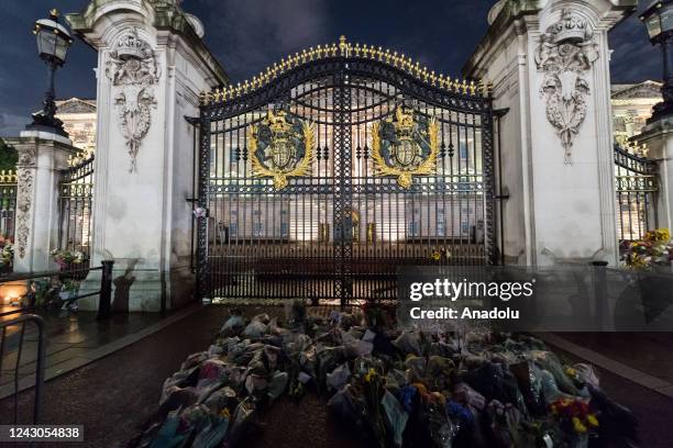 Floral tributes placed on the gates of Buckingham Palace by members of the public following the announcement of the death of Queen Elizabeth II in...