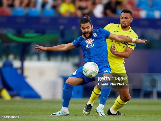 Joao Amaral of KKS Lech Poznan competes for the ball with Francis Coquelin of Villarreal CF during the UEFA Europa Conference League Group C match...