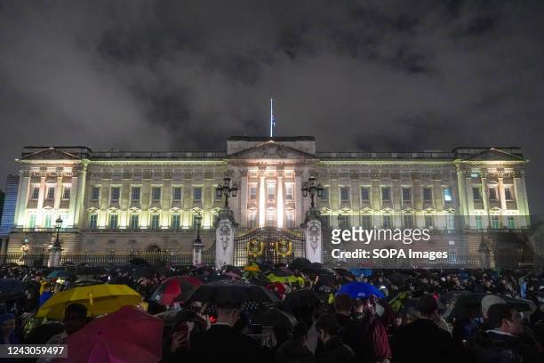 People gather at Buckingham Palace to pay their tributes to Queen Elizabeth II. Thousands of people gathered outside Buckingham Palace in central...