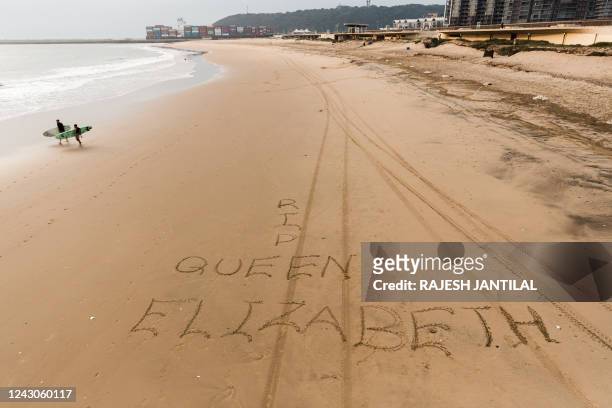 Picture taken on September 9, 2022 in Durban shows message written on sand on the South Beach on the passing of Queen Elisabeth II. Queen Elizabeth...