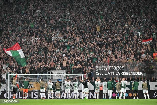 Ferencvaros players cheer to supporters to celebrate their 3-2 victory after the UEFA Europa League Group H football match between Ferencvaros TC and...