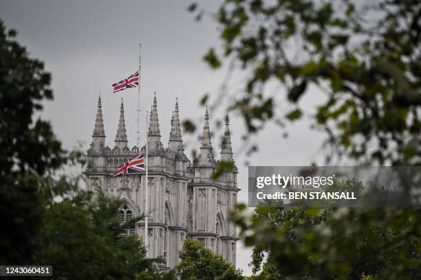 Union flag flies at half-mast at the top of Westminster Abbey, on September 9 a day after Queen Elizabeth II died at the age of 96. - Queen Elizabeth...