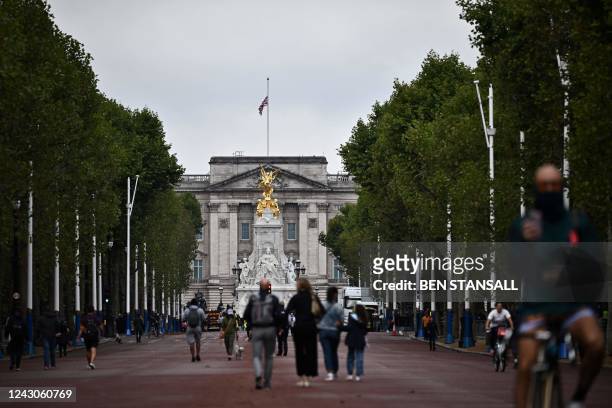 Union flag flies at half-mast at the top of Buckingham Palace in London on September 9 a pay people arrive to gather a day after Queen Elizabeth II...