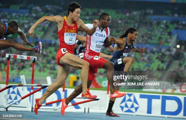 Cuba's Dayron Robles runs to victory over China's Liu Xiang and US athlete Jason Richardson as he competes in the men's 110 metres hurdles final at...