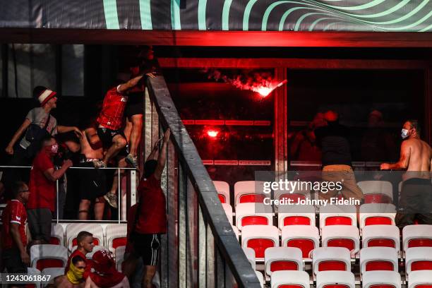 Fans Koln throw a flares against fans Nice before the UEFA Europa Conference League match between Nice and Koln at Allianz Riviera Stadium on...