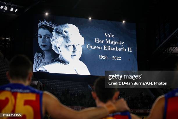 Players observe a minutes silence in memory of Her Majesty Queen Elizabeth II during the 2022 AFL Second Semi Final match between the Melbourne...