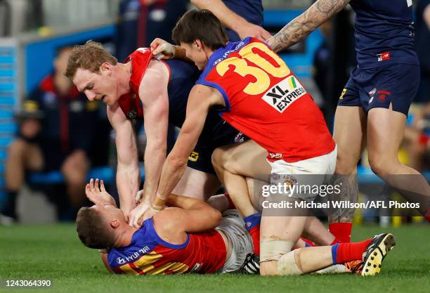 Dayne Zorko of the Lions and Harrison Petty of the Demons clash during the 2022 AFL Second Semi Final match between the Melbourne Demons and the...