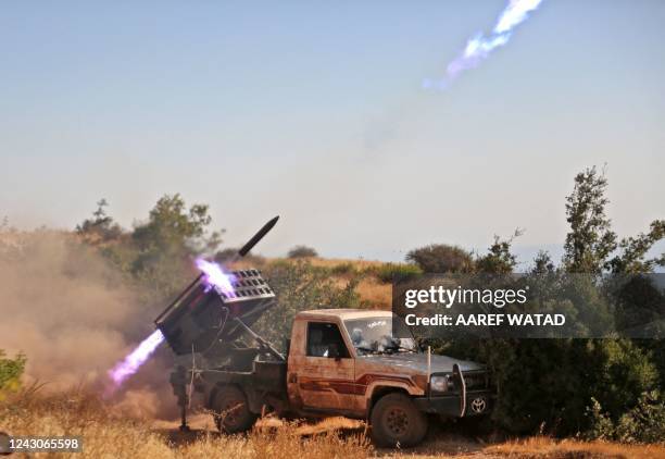 Syrian rebel fighters launch rockets from Jabal al-Turkman in the western countryside of the northwestern Latakia province, toward Syrian regime and...