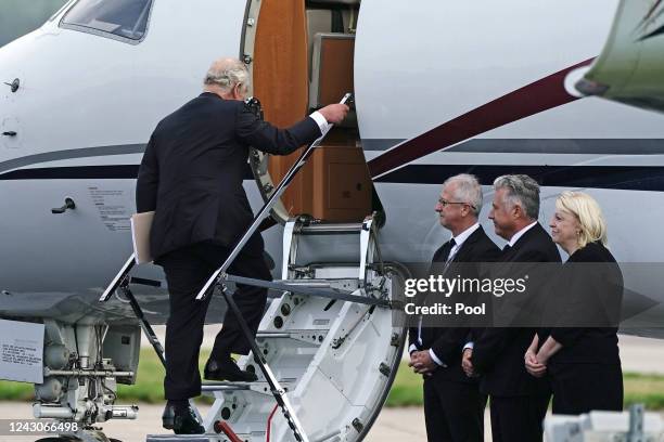 King Charles III boards a plane at Aberdeen Airport as he travels to London with Camilla, Queen Consort following the death of Queen Elizabeth II on...