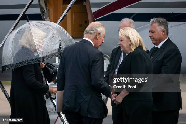 King Charles III and Camilla, Queen Consort are greeted at Aberdeen Airport before boarding a plane travel to London following the death of Queen...