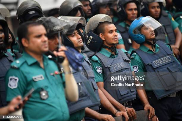 Policemen stand guard near BNP party office as Activists of Bangladesh Nationalist Party take part in a protest march in Dhaka on September 7 against...