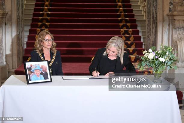 Sinn Fein's Michelle O'Neill signs a book of condolence at Belfast city hall alongside Mayor of Belfast Tina Black following the death of Her Majesty...