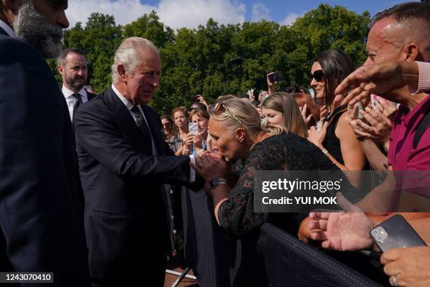 Britain's King Charles III greets members of the public waiting in the crowd upon arrival Buckingham Palace in London, on September 9 a day after...