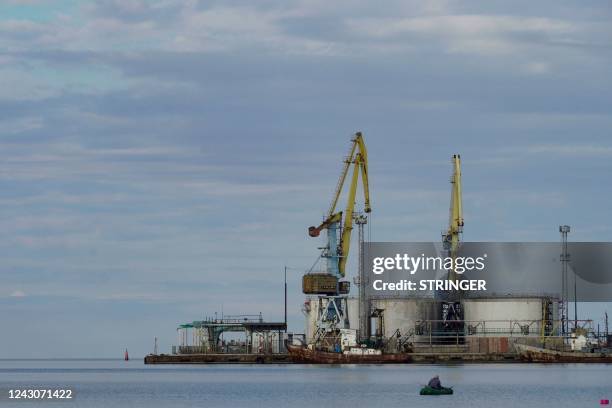 Man fishes in the port city of Berdyansk on the Sea of Azov on September 9 amid the ongoing Russia's military action in Ukraine.