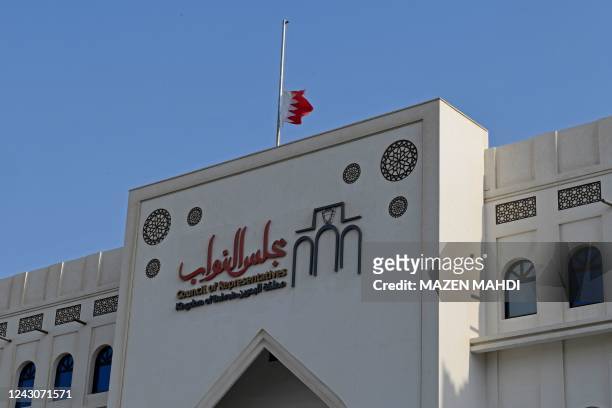 The Bahraini flag flies at half-mast above Bahrain's National Assembly building in the capital Manama on September 9, 2022 following the passing of...