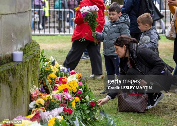 People lay flowers outside of the Palace of Holyrood House in Edinburgh on September 9 a day after Queen Elizabeth II died at the age of 96. - Queen...