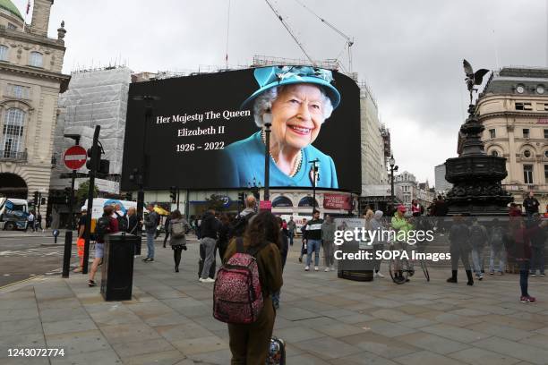 Piccadilly Circus billboard bears a Queen Elizabeth II picture. The world-renowned landmark that is the Piccadilly Circus advertising billboard in...