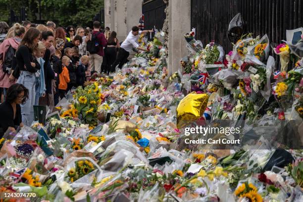 Flowers and tributes are laid outside Buckingham Palace on September 9, 2022 in London, United Kingdom. Elizabeth Alexandra Mary Windsor was born in...