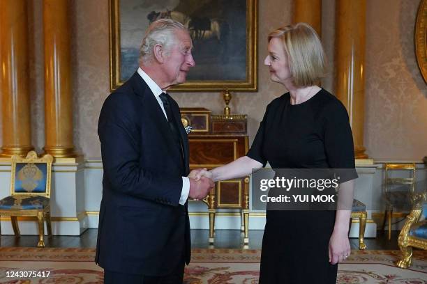 Britain's King Charles III greets Britain's Prime Minister Liz Truss during their first meeting at Buckingham Palace in London on September 9, 2022....