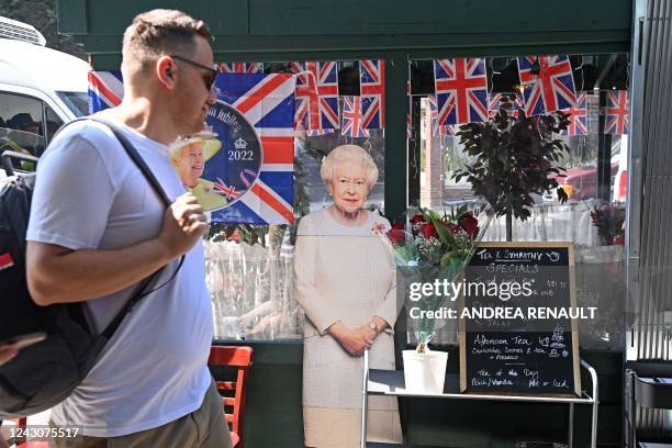 Man walks past a life-sized cut-out of Britain's Queen Elizabeth II outside the British owned business of Tea & Sympathy in Manhattans Greenwich...