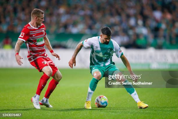 Andre Hahn of Augsburg fights for the ball with Anthony Jung of Bremen during the Bundesliga match between SV Werder Bremen and FC Augsburg at...