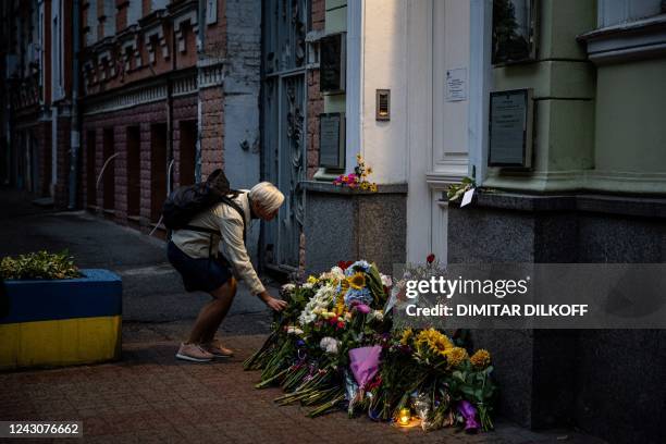 Woman leaves flowers outside British embassy in Kyiv on September 9 a day after Queen Elizabeth II died at the age of 96. Queen Elizabeth II, the...