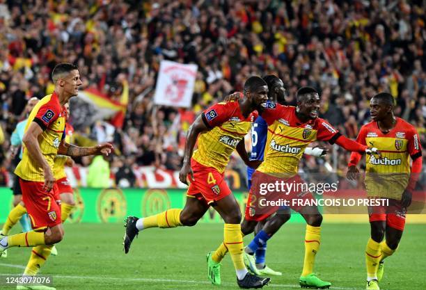 Lens' Austrian defender Kevin Danso celebrates with teammates after scoring his team's first goal during the French L1 football match between RC Lens...