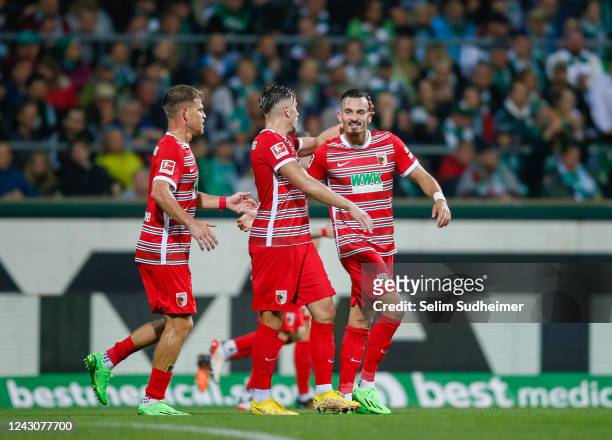 Ermedin Demirovic of Augsburg celebrates after scoring their teams first goal during the Bundesliga match between SV Werder Bremen and FC Augsburg at...