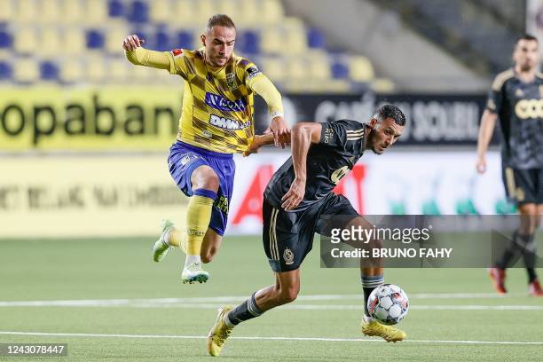 S Fatih Kaya and Standard's Selim Amallah fight for the ball during a soccer match between Sint-Truidense VV and Standard de Liege, Friday 09...