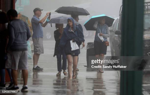 Visitors walk in Downtown Julian as winds and rain fall on September 9, 2022 in Julian, California. The Tropical Storm, which produced winds up to...