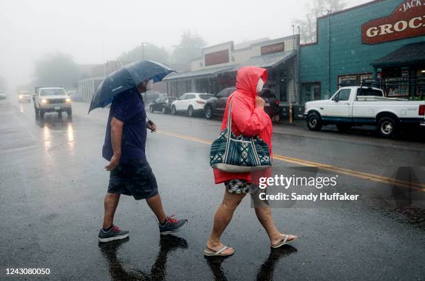 Visitors walk in Downtown Julian as winds and rain fall on September 9, 2022 in Julian, California. The Tropical Storm, which produced winds up to...