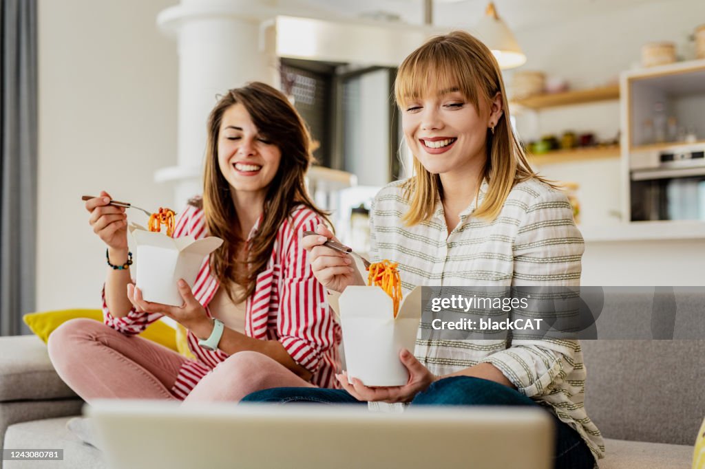 Two female friends ordered pasta to eat at home