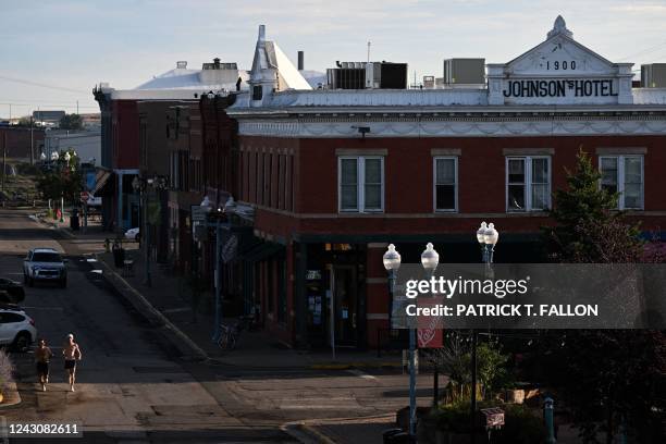 People run as the sun rises in downtown Laramie, Wyoming on August 13, 2022. - Nearly 25 years ago, the brutal murder of Matthew Shepard -- a gay...