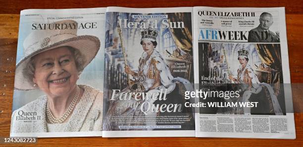 This photo illustration taken in Melbourne on September 10, 2022 shows front pages of Australian newspapers reporting on the death of Britain's Queen...