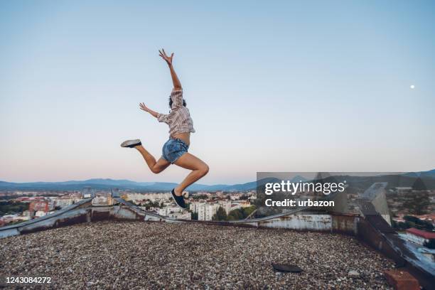 jumping on the rooftop - spread joy stock pictures, royalty-free photos & images