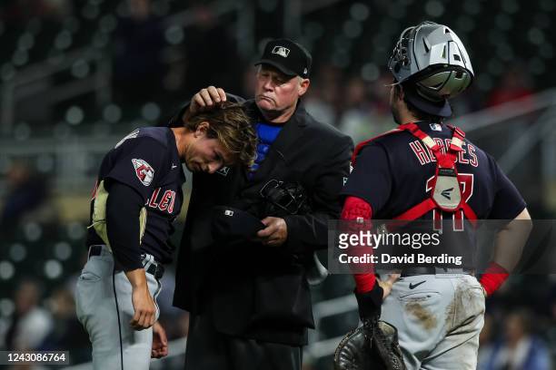 Umpire Ted Barrett checks James Karinchak of the Cleveland Guardians for foreign substances as Austin Hedges looks on in the eighth inning of the...